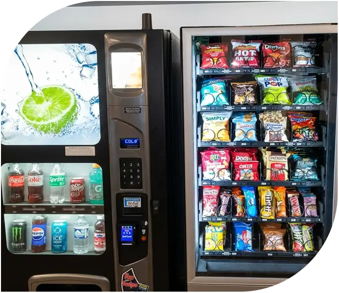 Modern vending machine stocked with snacks like Doritos, Cheetos, and Popchips, and beverages including Coca-Cola, water, and energy drinks, featuring a digital payment screen and fresh lime water splash graphic.